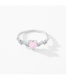 Macro detail of S925 silver ring featuring heart-shaped pink stone and wing zircon accents