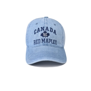 Détail de la broderie CANADA et de la feuille d'érable sur la casquette en denim bleu délavé