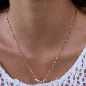 Elegant 18K gold plated stainless steel necklace with curved pearl smiley pendant