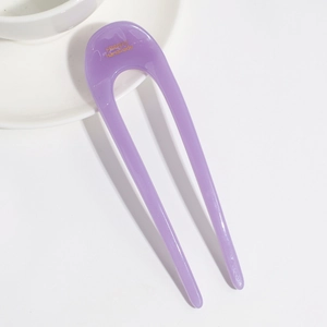 Detail of purple jelly U-shaped hair pin with France Handmade gold text on white tea set