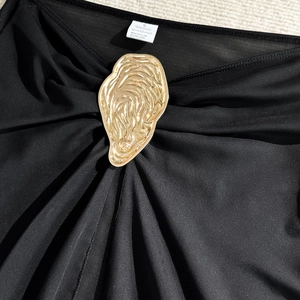 Detail of solid black bikini top with organic gold metal buckle and Size S label