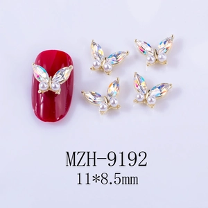 Detailed view of 3D butterfly nail charms with AB rhinestones and pearls for DIY art