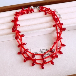 Detail of red tiered teardrop glass bead necklace with adjustable lobster clasp