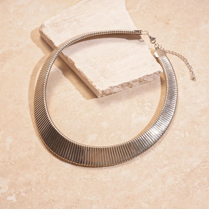 Detailed view of silver wide choker necklace with vertical striped metal texture