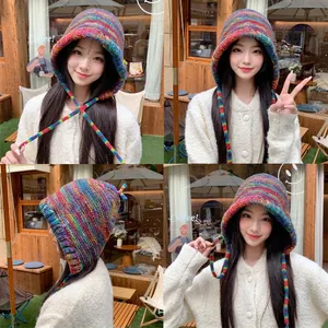 Rainbow striped knit earflap hat with colorful lace-up ties for winter warmth