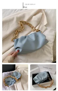 Detail view of light blue pouch bag featuring soft pleated leather and thick gold chain strap