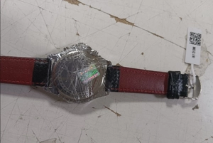 Close-up of MEGIR sports watch case back R1010 with genuine leather strap and tag