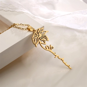 Detailed close-up of custom gold name necklace with lotus flower and Serena script