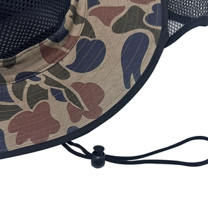 Detail of outdoor sun hat featuring breathable black mesh and camouflage pattern fabric