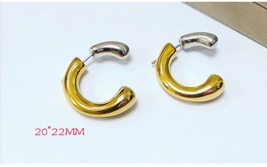 Detail view of stylish two-tone stainless steel chunky hoop earrings, modern geometric design.