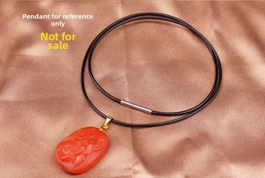 Close-up of black wax cord necklace with a stainless steel clasp on silk fabric