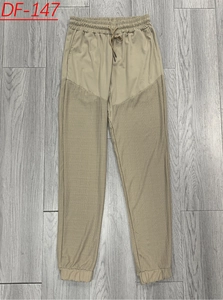 Macro detail of khaki drawstring waist and spliced textured fabric on men's linen pants