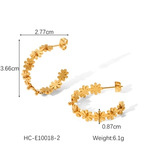 Detail view of golden flower-shaped C-hoop earrings with precise size measurements
