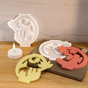 Ghost silicone molds for Halloween candles featuring hollow star details on wood surface
