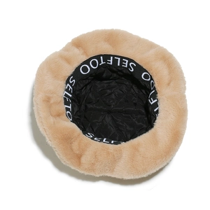 Detail view of the plush bucket hat featuring a quilted lining and logo sweatband