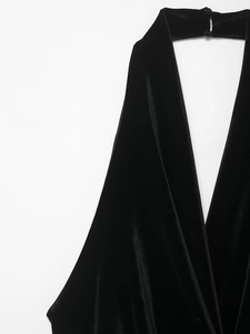 Close-up of black velvet halter dress neckline featuring elegant double button closure
