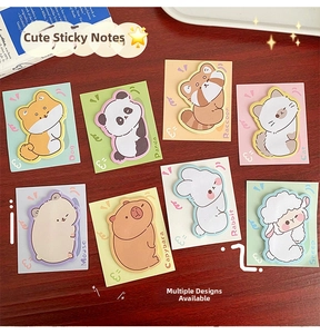 Detailed view of 8 animal-shaped sticky notes arranged on a wooden desk with a book