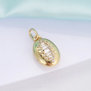 Macro view of a 18K gold-plated oval pendant with inlaid crystals and a pearl heart