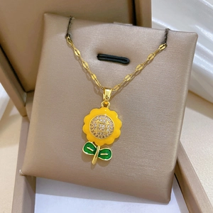 Macro detail of sunflower necklace with yellow enamel petals and sparkling zircon center