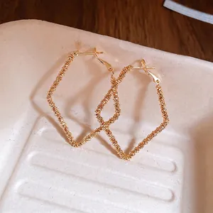 Irregular geometric diamond gold earrings with textured surface for women