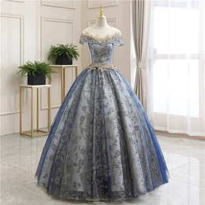 Detailed golden lace floral embroidery on luxury blue-gray tulle evening gown