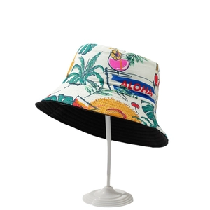 Reversible bucket hat with Hawaii palm tree prints and Aloha text in cream and black