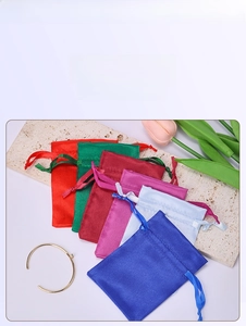 Macro view of colorful satin drawstring bags for jewelry with elegant silk texture