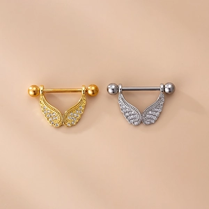 Macro view of gold and silver wing-shaped nipple shields with micro-pave zircons