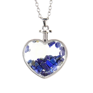Detailed macro view of heart-shaped pendant with blue natural stones and silver chain