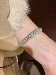Detailed view of vintage silver floral embossed cuff with zircon on sleeve