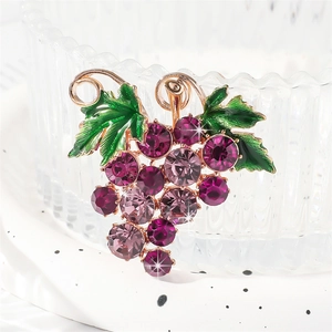 Elegant purple grape brooch with rhinestones and green leaf on a gold metal base