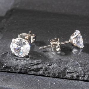Detailed macro view of 8mm round-cut cubic zirconia stud earrings with 4-prong setting