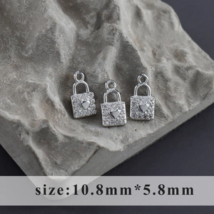 Detailed macro view of rhodium-plated heart lock pendants with cubic zirconia, 10.8x5.8mm