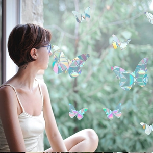 Detailed view of rainbow laser butterfly window decals with iridescent prism effects