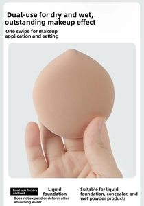 Close-up of peach-shaped makeup sponge showing dense texture for liquid foundation