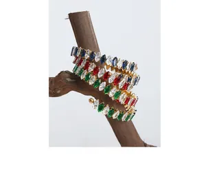 Detail of gold spiral bracelet with colorful marquise zircons on a branch