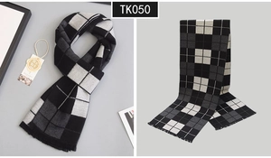 Detailed view of grey checkered wool scarf with soft fringe edges and product tag