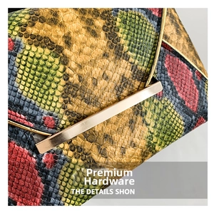 Detailed close-up of multi-color snakeskin texture with polished gold metal hardware