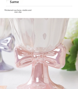 Detailed view of pink pearlescent ceramic goblet with bow decoration and thickened stable base