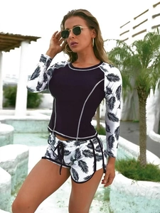 Close-up of long sleeve surfing top with contrast stitching and feather print details