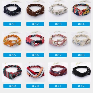 Close-up showing various patterns of twisted elastic headbands with floral and boho prints