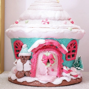 Light-up gingerbread candy house decoration with snow-covered tree and gingerbread man