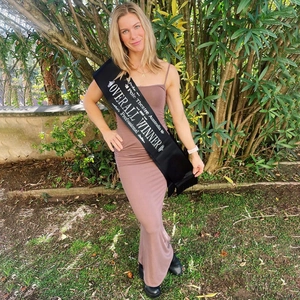 Brown backless bodycon maxi dress detail with a professional winner sash on a model