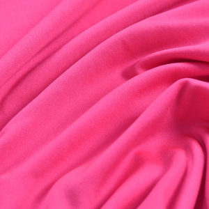 Detailed macro view of the soft fuchsia pink knitted fabric with textured ruching effects