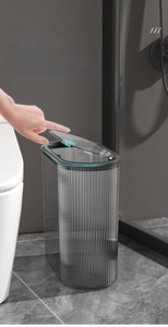 Modern dark grey transparent trash can with press-top lid for narrow bathroom spaces