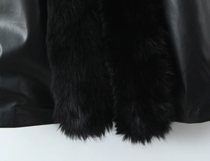 Detailed view of the luxury black faux fur collar and smooth premium leather fabric texture