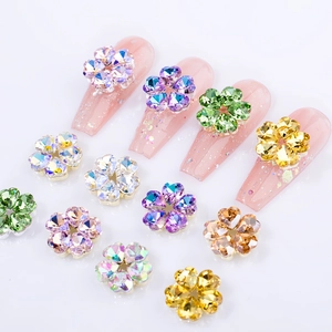 Detailed view of crystal flower nail charms with heart-shaped petals in various colors