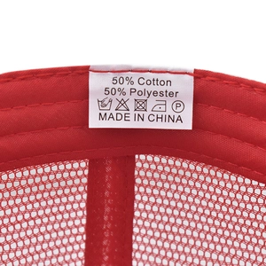 Close-up of the washing label showing 50% cotton 50% polyester on a red mesh cap