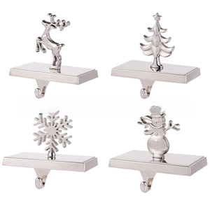 Detail showing set of four silver metal fireplace mantle hooks with festive shapes