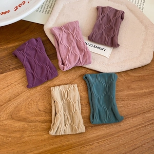 Close-up of high-elasticity knitted hair ties featuring unique wavy texture in five colors